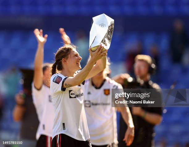 Hannah Blundell of Manchester United celebrates with the Manchester United Player of the year Trophy after the final whistle of the FA Women's Super...