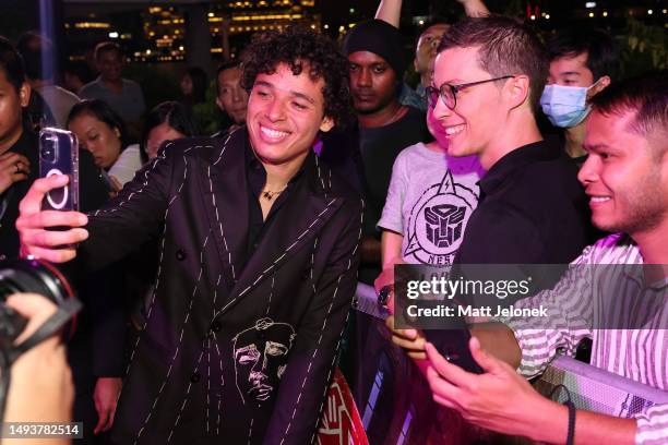 Anthony Ramos poses for a selfie with a fan at the World Premiere of Paramount Pictures' "Transformers: Rise of the Beasts" at Marina Bay Sands on...