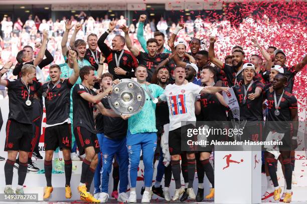 Manuel Neuer and Thomas Mueller of FC Bayern Munich celebrate with the Bundesliga Meisterschale trophy after the team's victory in the Bundesliga...
