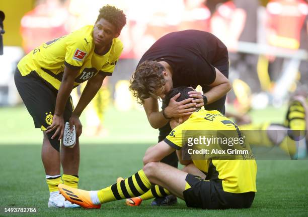 Edin Terzic, Julien Duranville and Giovanni Reyna of Borussia Dortmund look dejected following the team's draw, as they finish second in the...