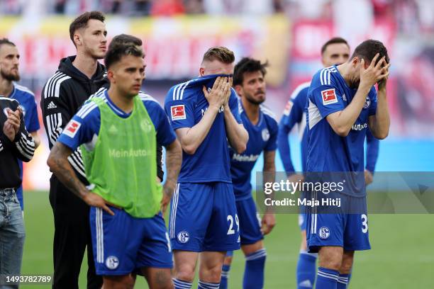 Tobias Mohr of FC Schalke 04 and teammates look dejected and react after the team's defeat leading to their relegation after the Bundesliga match...