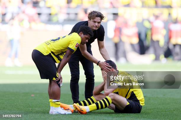 Edin Terzic, Julien Duranville and Giovanni Reyna of Borussia Dortmund look dejected following the team's draw, as they finish second in the...