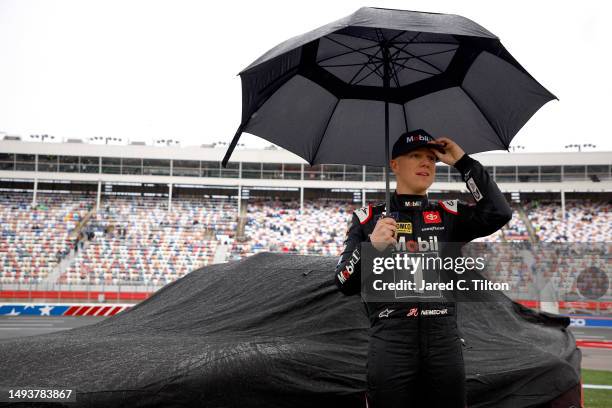 John Hunter Nemechek, driver of the Mobil 1 Toyota, waits on the grid under an umbrella prior to the NASCAR Xfinity Series Alsco Uniforms 300 at...