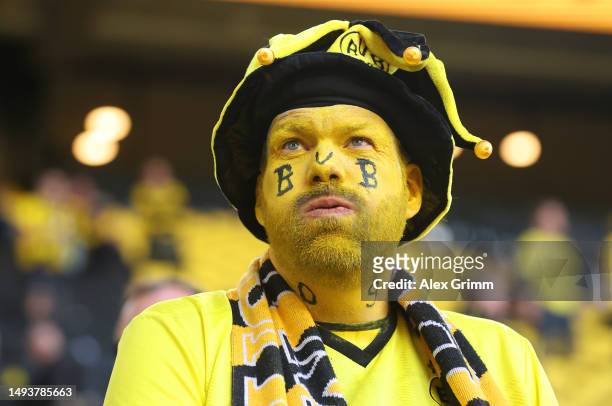 Borussia Dortmund fan looks dejected following the team's draw, as they finish second in the Bundesliga behind FC Bayern Munich during the Bundesliga...