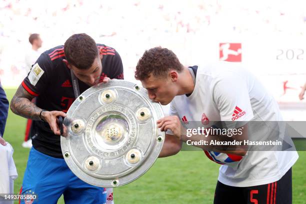 Lucas Hernandez and Benjamin Pavard of FC Bayern Munich celebrate with the Bundesliga Meisterschale trophy after the team's victory in the Bundesliga...