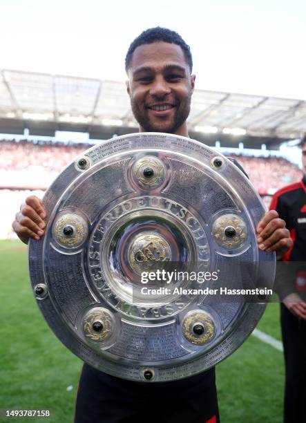 Serge Gnabry of FC Bayern Munich celebrates with the Bundesliga Meisterschale trophy after the team's victory in the Bundesliga match between 1. FC...