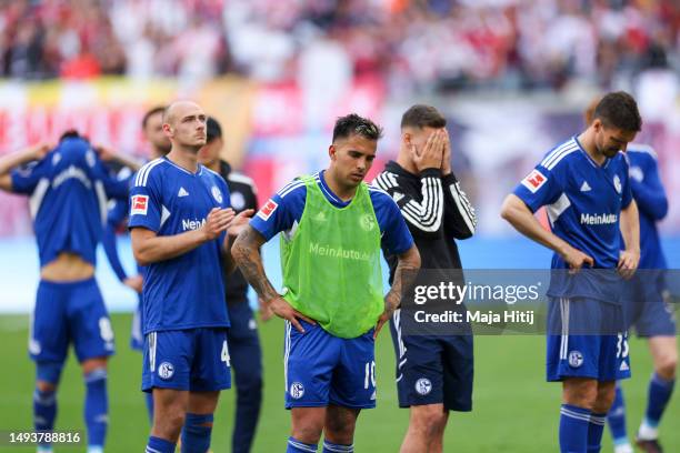 Rodrigo Zalazar of FC Schalke 04 and players react after the Bundesliga match between RB Leipzig and FC Schalke 04 at Red Bull Arena on May 27, 2023...