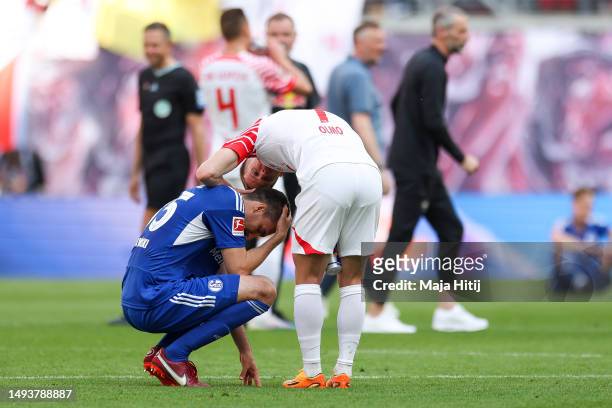 Dani Olmo hugs Marcin Kaminski of FC Schalke 04 as he reacts after the Bundesliga match between RB Leipzig and FC Schalke 04 at Red Bull Arena on May...