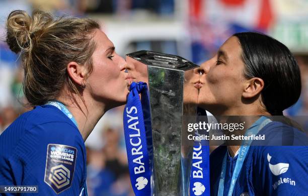 Millie Bright and Sam Kerr of Chelsea kiss the Barclays Women's Super League trophy after the team's victory during the FA Women's Super League match...