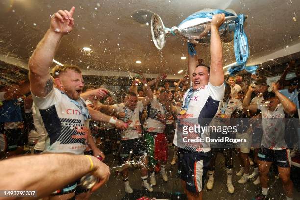 Jamie George of Saracens lifts the Gallagher Premiership trophy in the dressing room after the team's victory during the Gallagher Premiership Final...