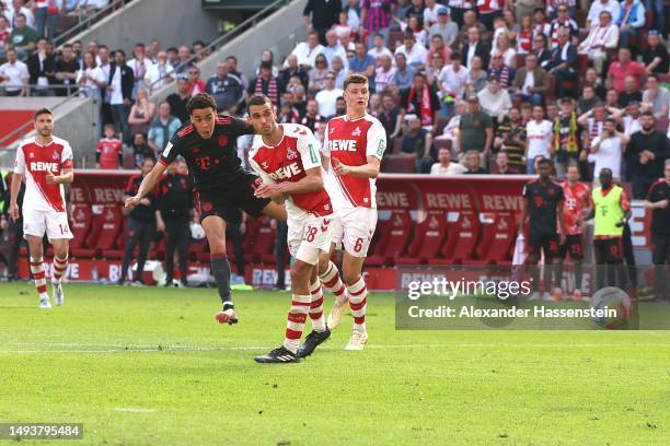 Jamal Musiala of FC Bayern Munich scores the team's second goal during the Bundesliga match between 1. FC Köln and FC Bayern München at...