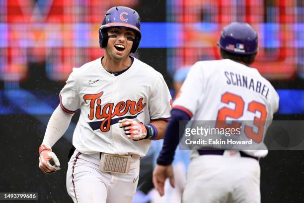 Blake Wright of the Clemson Tigers celebrates with assistant head coach Nick Schnabel as he rounds third base after hitting a home run against the...