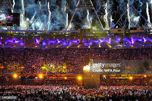 Flames leap from the cauldron and fireworks explode during the Opening Ceremony of the London 2012 Olympic Games at the Olympic Stadium on July 27,...