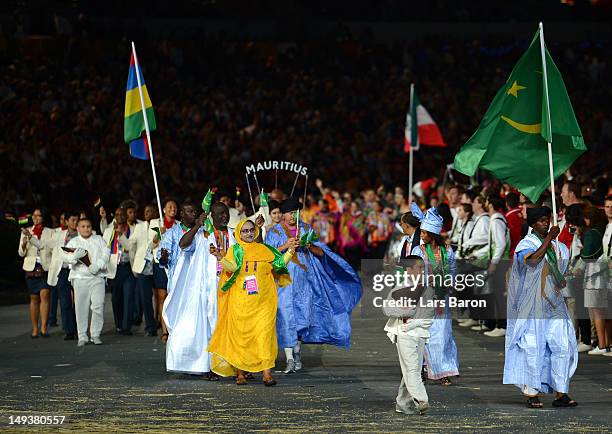 Jidou El Moctar of the Mauritania Olympic athletics team carries his country's flag during the Opening Ceremony of the London 2012 Olympic Games at...