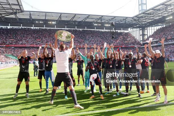 Joshua Kimmich of FC Bayern Munich celebrates with the Bundesliga Meisterschale trophy after the team's victory in the Bundesliga match between 1. FC...