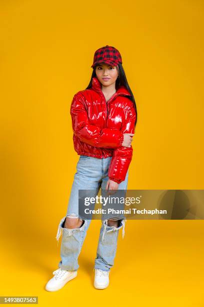 girl wearing red puffer jacket and jeans - street fashion asian stock pictures, royalty-free photos & images