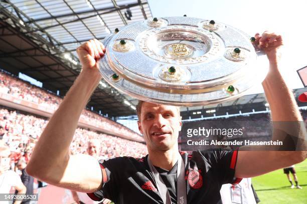 Thomas Müller of FC Bayern Munich celebrates with the Bundesliga Meisterschale trophy after the team's victory in the Bundesliga match between 1. FC...