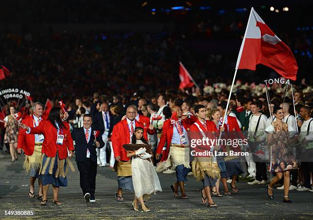 Amini Fonua of the Tonga Olympic swimming team carries his country's flag during the Opening Ceremony of the London 2012 Olympic Games at the Olympic...