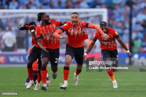 Players of Luton Town celebrate after Fankaty Dabo of Coventry City misses a penalty in the penalty shoot out which results in a promotion to the...