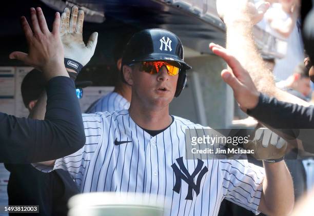 LeMahieu of the New York Yankees celebrates his seventh inning home run against the San Diego Padres in the dugout with his teammates at Yankee...