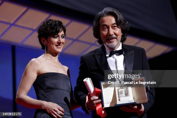 Koji Yakusho receives the Best Actor Award for 'Perfect Days' from Zar Amir-Ebrahimi during the closing ceremony during the 76th annual Cannes film...