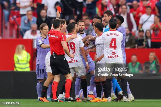 Referee, Soto Grado shows a red card to Marcos Acuna of Sevilla FC during the LaLiga Santander match between Sevilla FC and Real Madrid CF at Estadio...