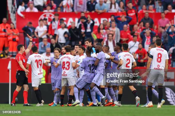 Referee, Soto Grado shows a red card to Marcos Acuna of Sevilla FC during the LaLiga Santander match between Sevilla FC and Real Madrid CF at Estadio...