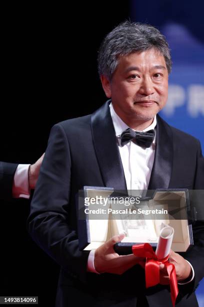Hirokazu Koreeda receives the The Award for Best Screenplay for Kaibutsu onstage during the closing ceremony during the 76th annual Cannes film...