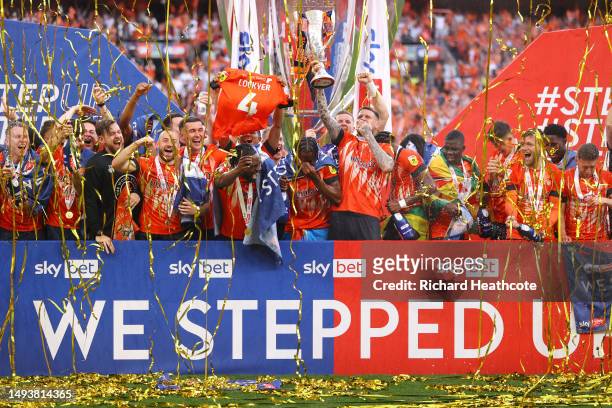 Players of Luton Town celebrate with the Sky Bet Championship Play Offs Final trophy following their team’s victory in the Sky Bet Championship...