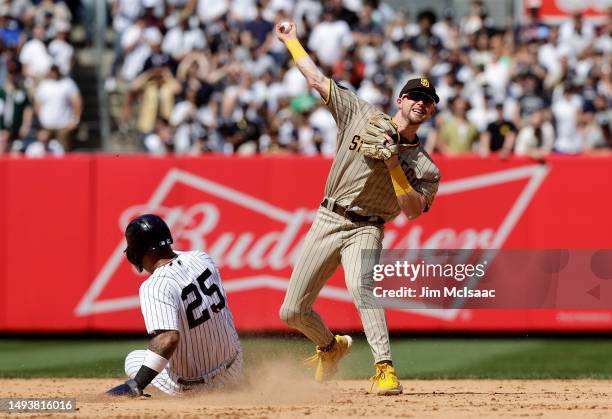 Jake Cronenworth of the San Diego Padres completes a ninth inning double play after forcing out Gleyber Torres of the New York Yankees at Yankee...