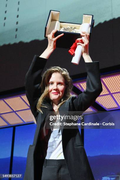 Justine Triet receives The Palme D'Or Award for 'Anatomy of a Fall' during the closing ceremony during the 76th annual Cannes film festival at Palais...