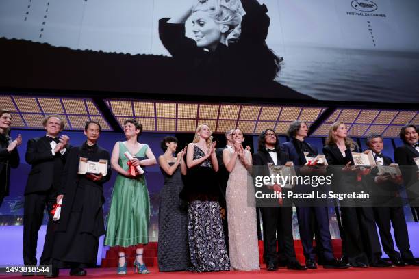 Laureates and hosts celebrate on stage during the closing ceremony during the 76th annual Cannes film festival at Palais des Festivals on May 27,...