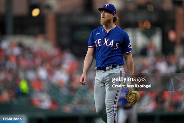 Jon Gray of the Texas Rangers walks back to the dugout after striking out Ryan O'Hearn of the Baltimore Orioles to end the second inning at Oriole...