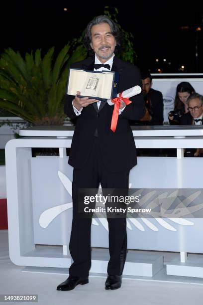 Kōji Yakusho poses the Best Actor Award for 'Perfect Days' during the Palme D'Or winners photocall at the 76th annual Cannes film festival at Palais...