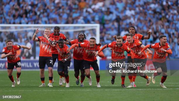 Luton Town players celebrate after Fankaty Dabo of Coventry City misses a penalty in the penalty shoot out which results in a promotion to the...