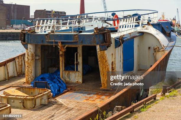 wrecked prow of a trawler lying at the quay - boat ruins stock pictures, royalty-free photos & images