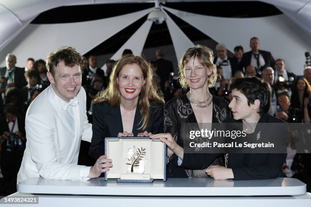 Antoine Reinartz, Director Justine Triet, Sandra Hüller and Milo Machado Graner pose with The Palme D'Or Award for 'Anatomy of a Fall' during the...