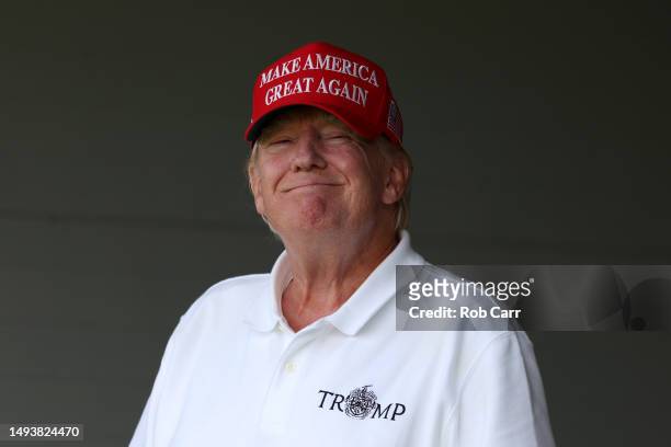 Former US President Donald Trump looks on from the 18th green during day two of the LIV Golf Invitational - DC at Trump National Golf Club on May 27,...