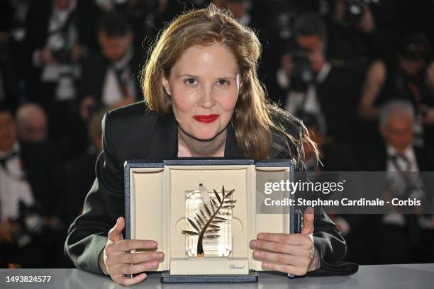 Justine Triet poses with The Palme D'Or Award for 'Anatomy of a Fall' during the Palme D'Or winners photocall at the 76th annual Cannes film festival...