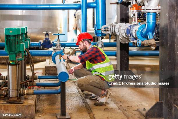 performing safety checks at the heating plant - district heating plant stock pictures, royalty-free photos & images