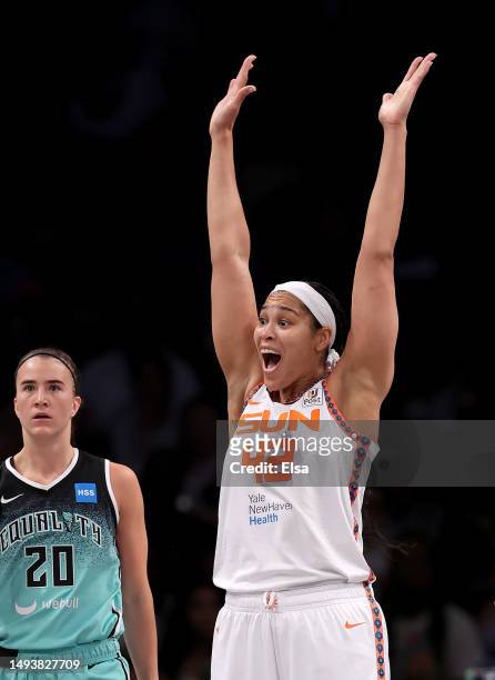 Brionna Jones of the Connecticut Sun reacts after she is called for a foul as Sabrina Ionescu of the New York Liberty looks on in the second half at...