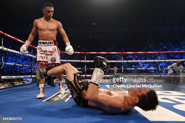 Michael Conlan is knocked down by Luis Alberto Lopez during their IBF world featherweight title fight at The SSE Arena Belfast on May 27, 2023 in...