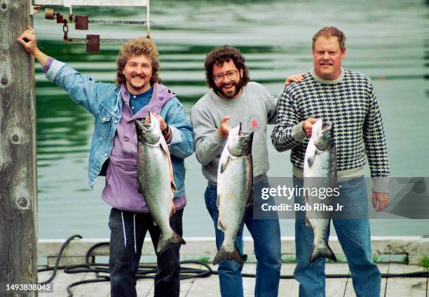 American Fishermen : Norman Lono and David Handschuh from New York, NY and Dan Madden from Long Beach, CA display a morning catch of Salmon on a...