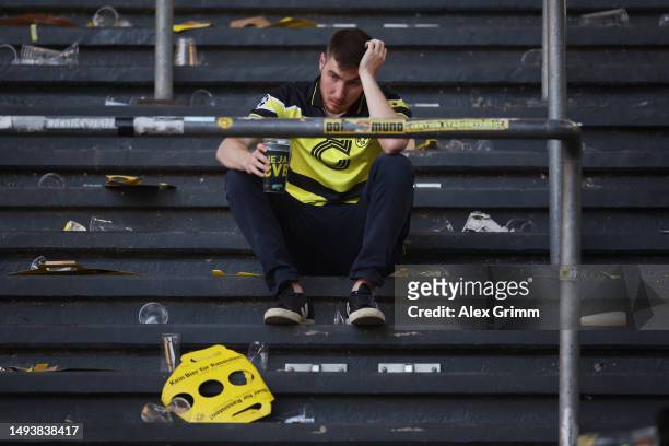 Fan of Borussia Dortmund looks dejected following the team's draw, as they finish second in the Bundesliga behind FC Bayern Munich during the...