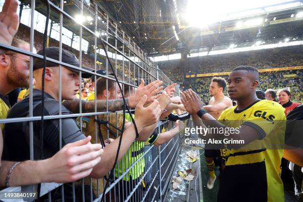 Youssoufa Moukoko of Borussia Dortmund acknowledges the fans following the team's draw, as they finish second in the Bundesliga behind FC Bayern...