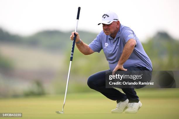 Thomas Bjorn of Denmark lines up a putt on the second green during the third round of the KitchenAid Senior PGA Championship at Fields Ranch East at...