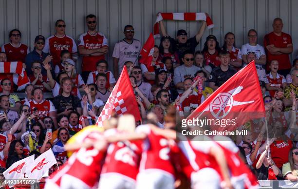 Arsenal fans cheer as the team huddle ahead of the FA Women's Super League match between Arsenal and Aston Villa at Meadow Park on May 27, 2023 in...
