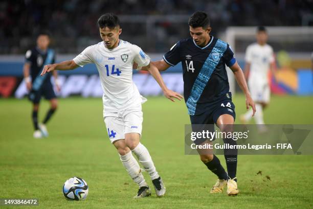 Jonathan Franco of Guatemala competes for the ball with Abbosbek Fayzullaev of Uzbekistan during the FIFA U-20 World Cup Argentina 2023 Group B match...