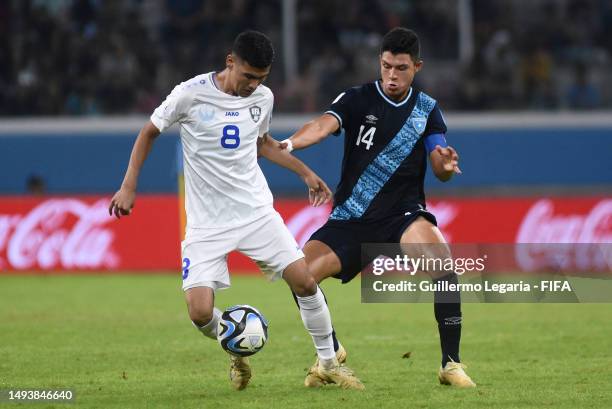Jonathan Franco of Guatemala competes for the ball with Bekhruzbek Askarov of Uzbekistan during the FIFA U-20 World Cup Argentina 2023 Group B match...
