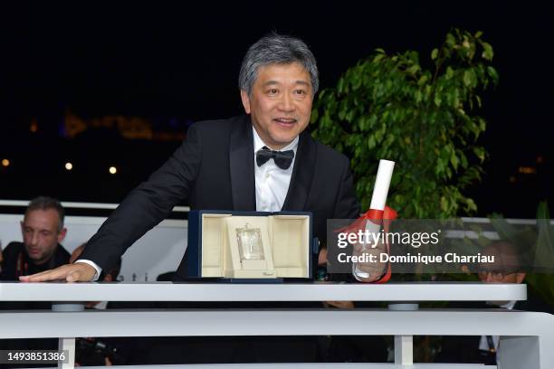 Hirokazu Kore-eda poses with The Award for Best Screenplay for 'Kaibutsu' during the Palme D'Or winners photocall at the 76th annual Cannes film...